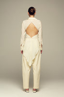 IKINITA butter yellow Ulysse pants laid flat, showing the stylish, high-waisted design and smooth fabric for a casual look.