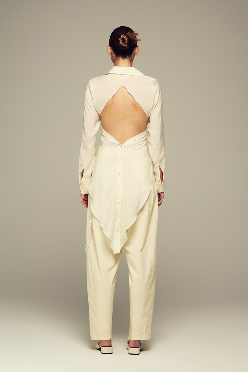 IKINITA butter yellow Ulysse pants laid flat, showing the stylish, high-waisted design and smooth fabric for a casual look.