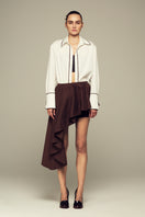 Brown modular mini skirt by IKINITA, featuring layered design and adjustable fit, shown on a neutral background.