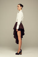 White boyfriend shirt from IKINITA, shown on a hanger with collar and button details visible.