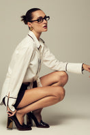 White boyfriend shirt by IKINITA, featuring a relaxed fit and classic collar, displayed on a mannequin.