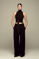 Brown IKINITA Moon Pants displayed flat, showing their relaxed fit, high waist, and stylish design.