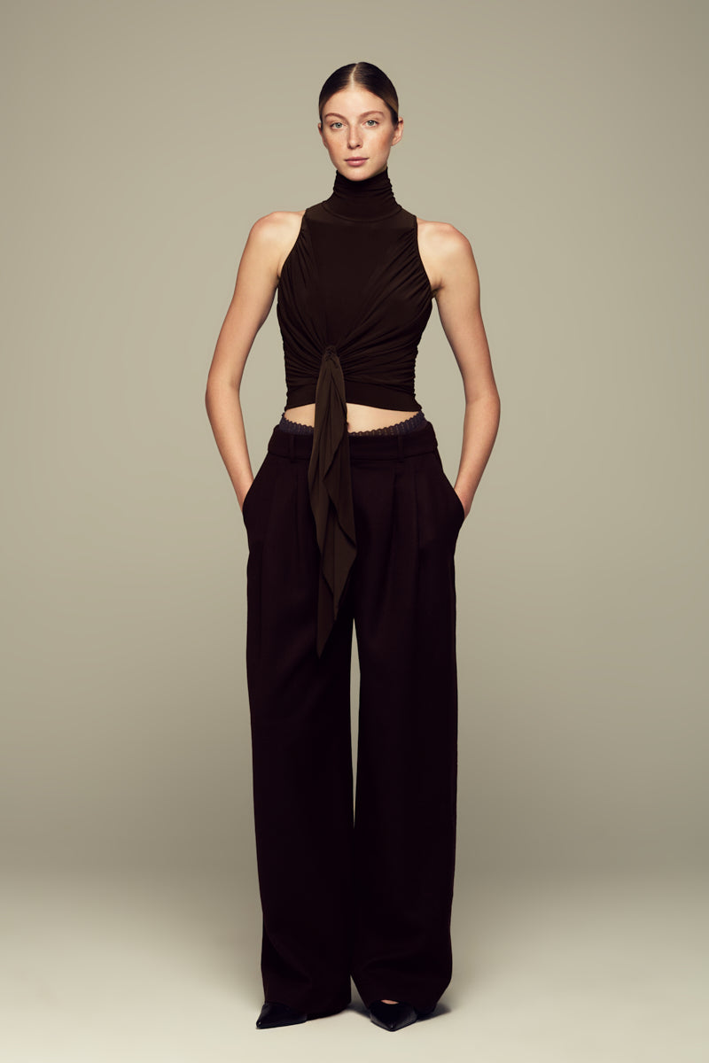 Brown IKINITA Moon Pants displayed flat, showing their relaxed fit, high waist, and stylish design.