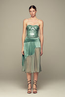 Emerald green NAUSICA midi skirt by IKINITA, featuring a flowing fabric and stylish design, displayed on a plain background.