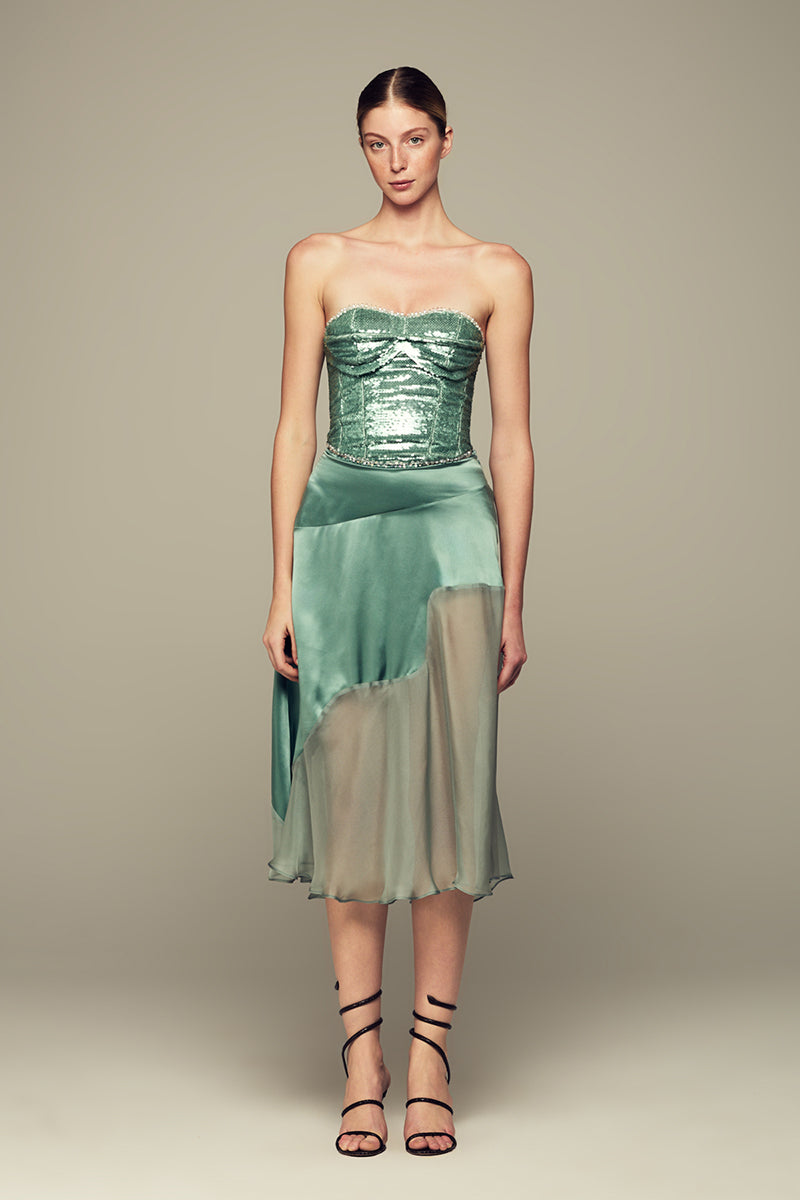 Emerald green NAUSICA midi skirt by IKINITA, featuring a flowing fabric and stylish design, displayed on a plain background.