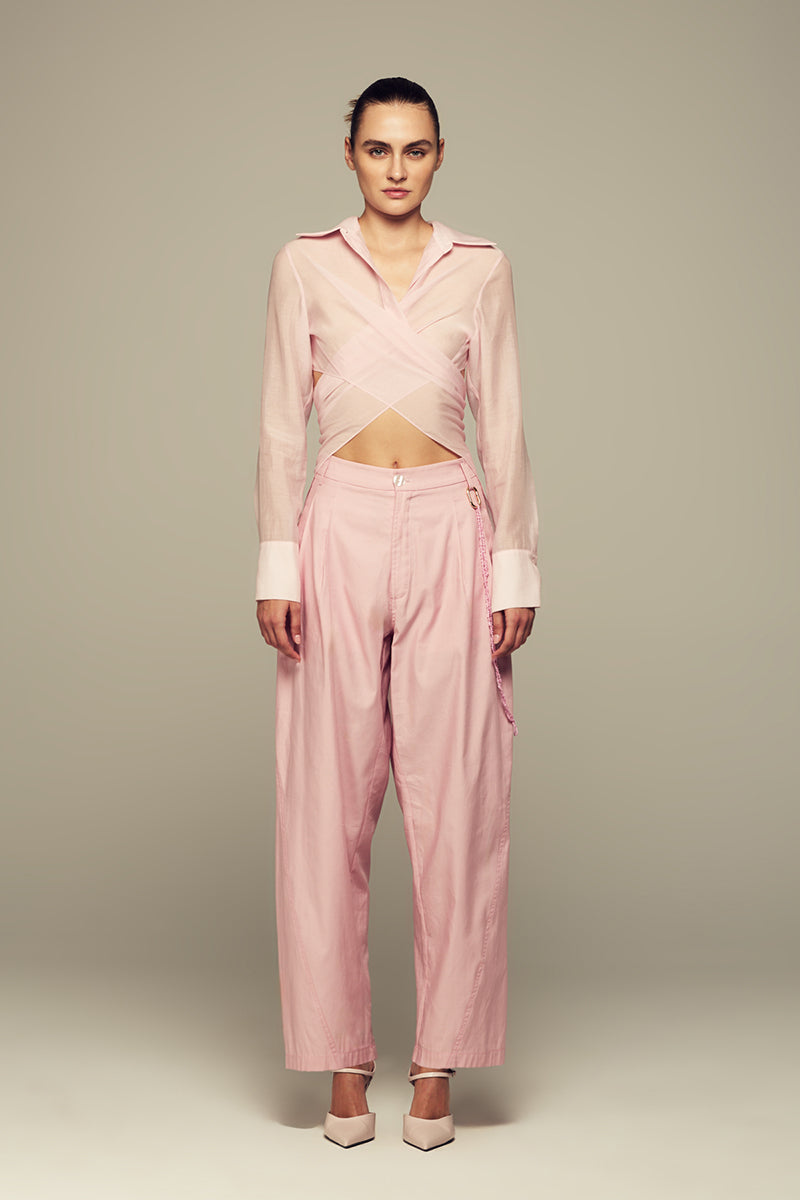 Pink Ulysse shirt by IKINITA displayed on a hanger, showcasing its stylish collar and lightweight fabric.