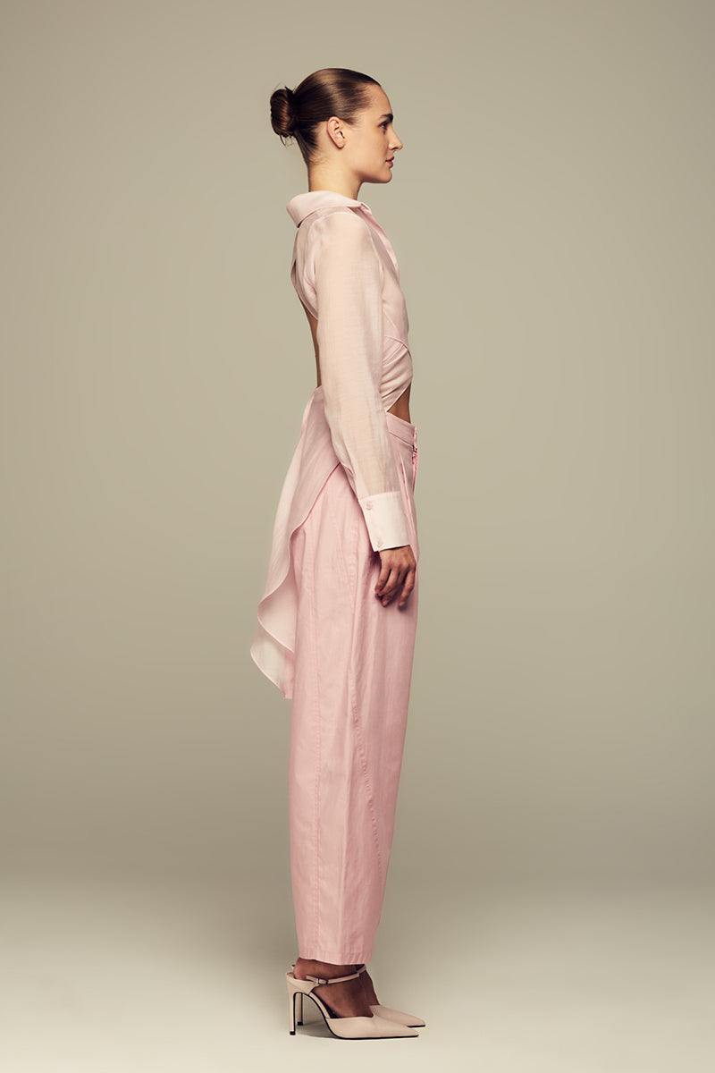 Pink IKINITA ULYSSE pants with a relaxed fit, featuring a comfortable waistband and stylish design.