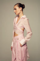 Pink IKINITA ULYSSE shirt displayed on a hanger, showcasing the soft fabric and stylish design of the women's shirt.