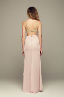 Pink IKINITA Lotus Eater maxi skirt with flowing fabric and waistband, shown on a model.