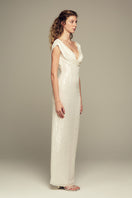 White Scylla gown by IKINITA, elegant long dress with flowing fabric and sophisticated design, perfect for formal occasions.