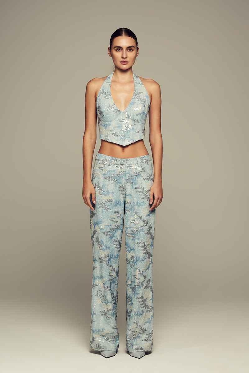 Blue IRIS top by IKINITA, featuring a stylish and comfortable design, shown in a close-up of the fabric and neckline.