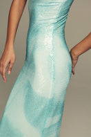 Blue water gown by IKINITA featuring flowing fabric and elegant design, perfect for formal occasions.