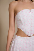 Pink polka dot top from IKINITA, featuring a stylish design, displayed on a white background.