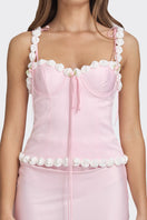 Light pink cake bustier top by Stolen Stores, featuring a fitted design and decorative details on the front.