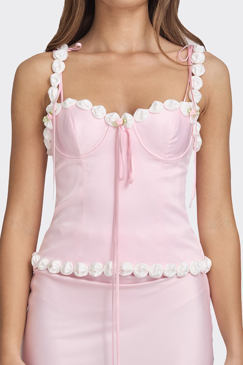 Light pink cake bustier top by Stolen Stores, featuring a fitted design and decorative details on the front.
