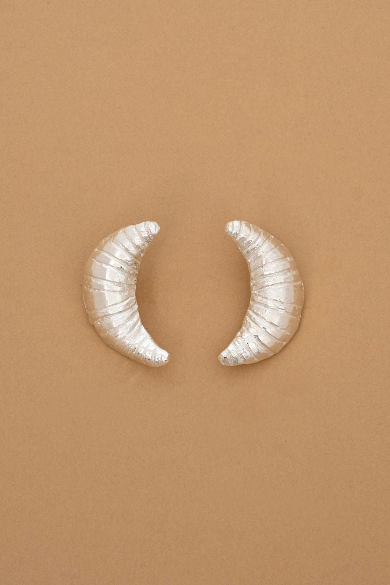 Silver croissant earrings by Oz Objects featuring detailed, crescent-shaped designs, perfect for stylish everyday wear.