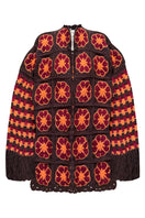 Jessica K brown Imagine jacket cardigan hanging on a wooden hanger, showcasing its cozy knit texture and stylish design.