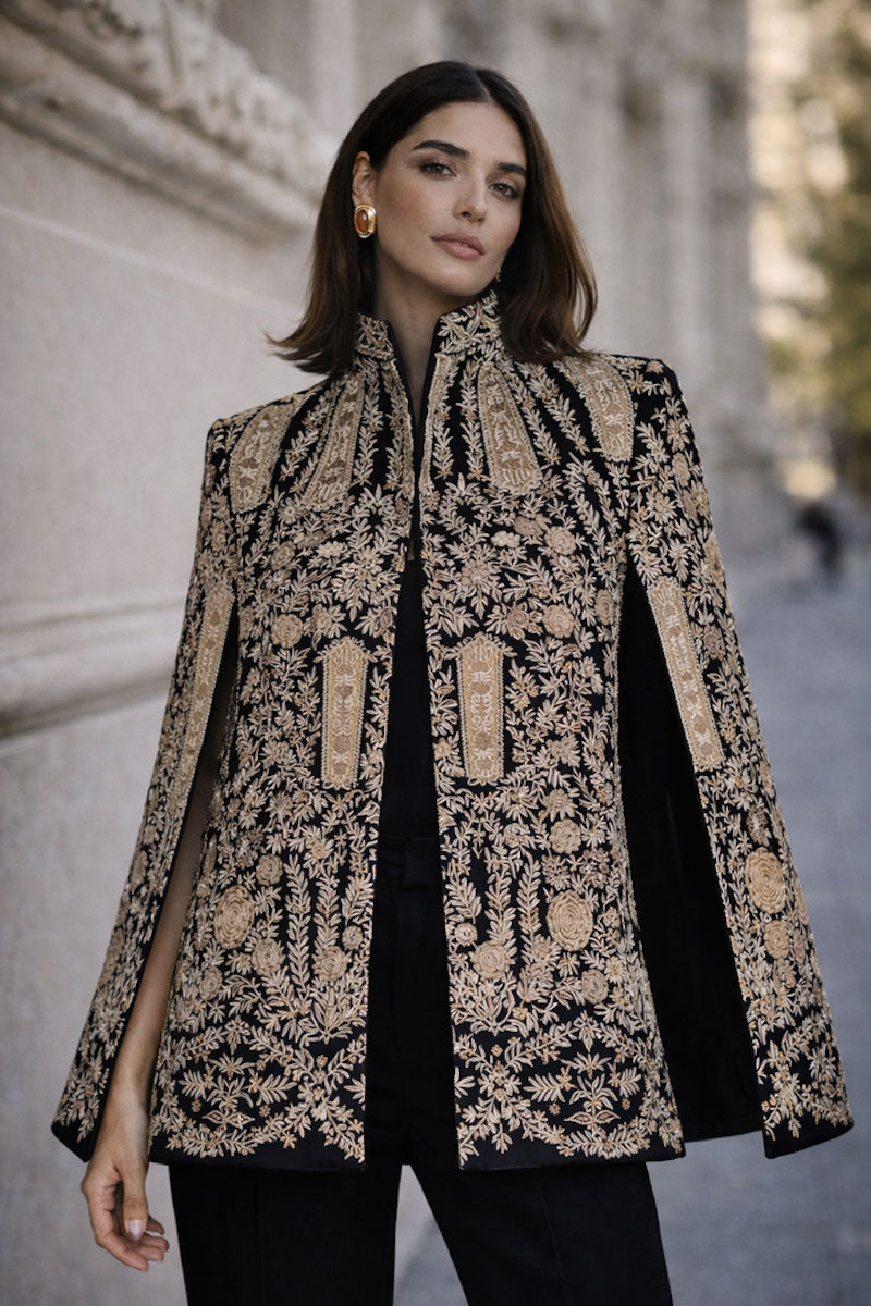 Nadya Shah Astrid in Byzantine cape jacket with intricate embroidery and flowing fabric, worn open over a stylish outfit.