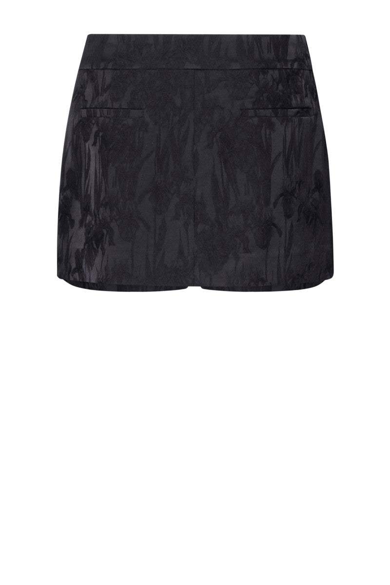 Black LEKIEU Amiens mini skirt displayed flat with smooth fabric and clean hem, showcasing a stylish women's fashion piece.