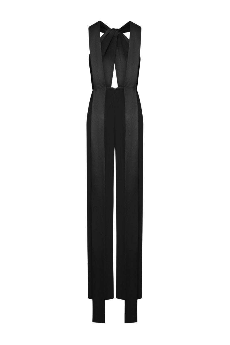 Black LEKIEU ELYSÉES jumpsuit with long sleeves and fitted silhouette, shown on a model in a stylish indoor setting.