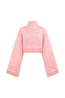 Pink Sayya sweater with a cozy knit design, displayed on a hanger against a neutral background.