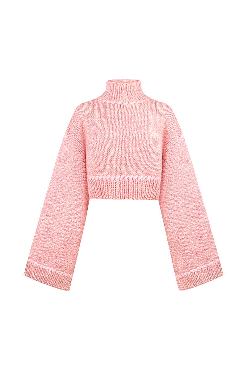 Pink Sayya sweater with a cozy knit design, displayed on a hanger against a neutral background.