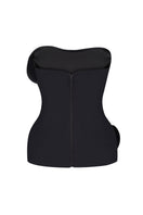 Black Nué Christelle corset top with structured design and adjustable straps, shown on a model.