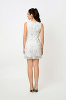 Valenciani mini lace dress with floral appliqué, showcasing intricate lace details and delicate floral embellishments.