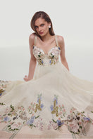 BY HAÓ Fleuria asymmetric bustier maxi dress in Jardin with floral pattern and fitted bodice on model.