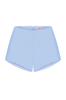 Nué Delphine shorts in lightweight fabric, featuring a stylish design and comfortable fit, shown in a casual outdoor setting.
