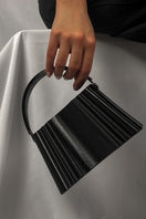 Black silk clutch bag by Touchless, sleek and elegant with a smooth fabric exterior and compact design for evening use.
