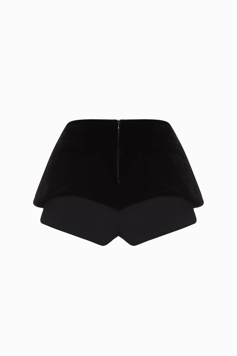 Black Balykina double shorts with a relaxed fit, shown on a model in a casual outdoor setting.