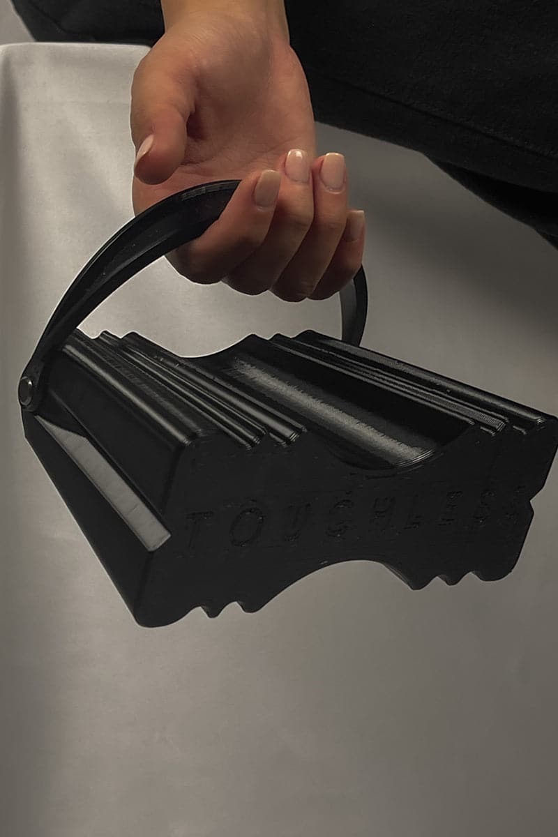 Touchless black silk clutch bag with sleek design, featuring a compact, elegant style for formal occasions and evening outings.