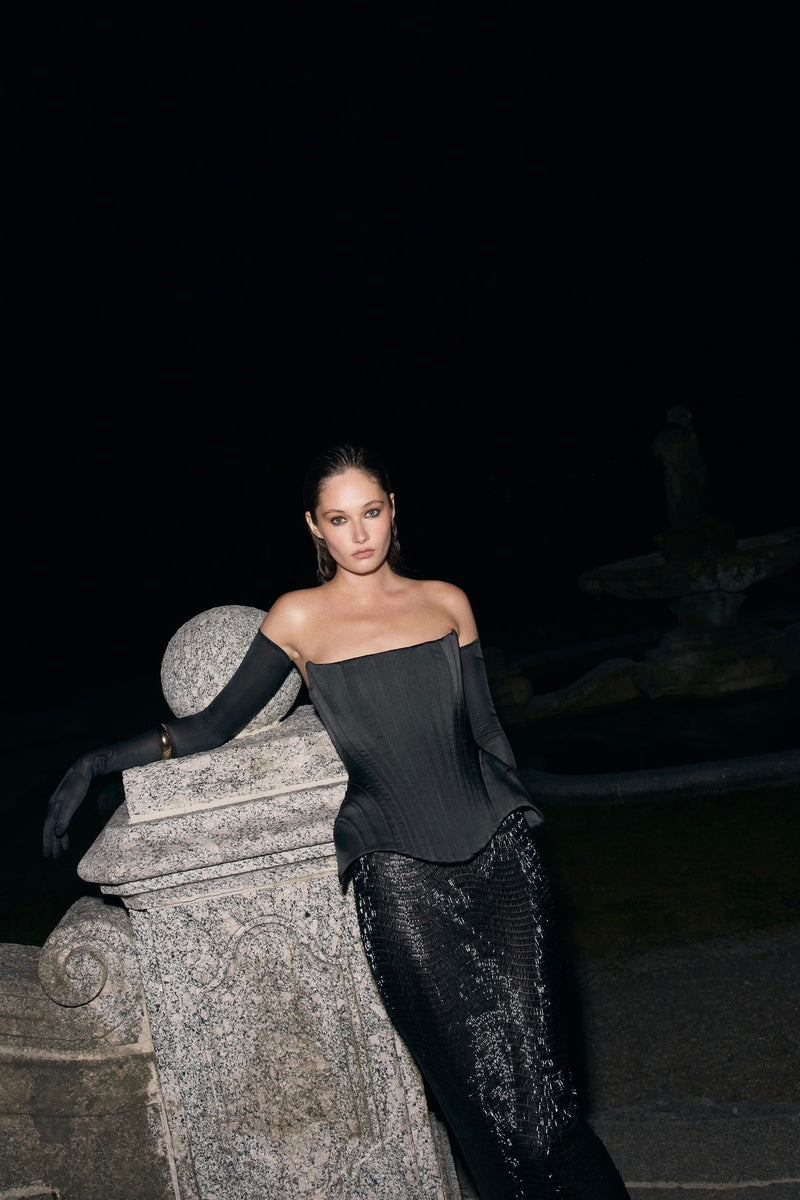 Black Irma corset top by Balykina featuring structured design and lace-up details, worn with a stylish, fitted look.