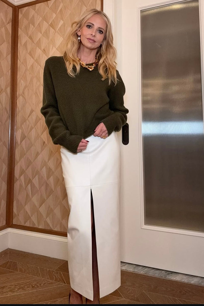 Ecru Kris Marán fit cut midi skirt with front slit, showcasing sleek design and elegant silhouette.