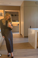 Brown leather midi skirt by Kris Marán, showcasing a sleek, high-waisted design with smooth texture and versatile style.
