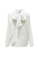 Arti Apparel Cora Top, stylish women's blouse with floral pattern and short sleeves, displayed on a hanger.