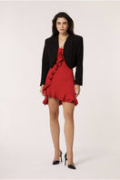 Red Señorita Penelope mini dress displayed on a hanger, showcasing its stylish design and vibrant color.