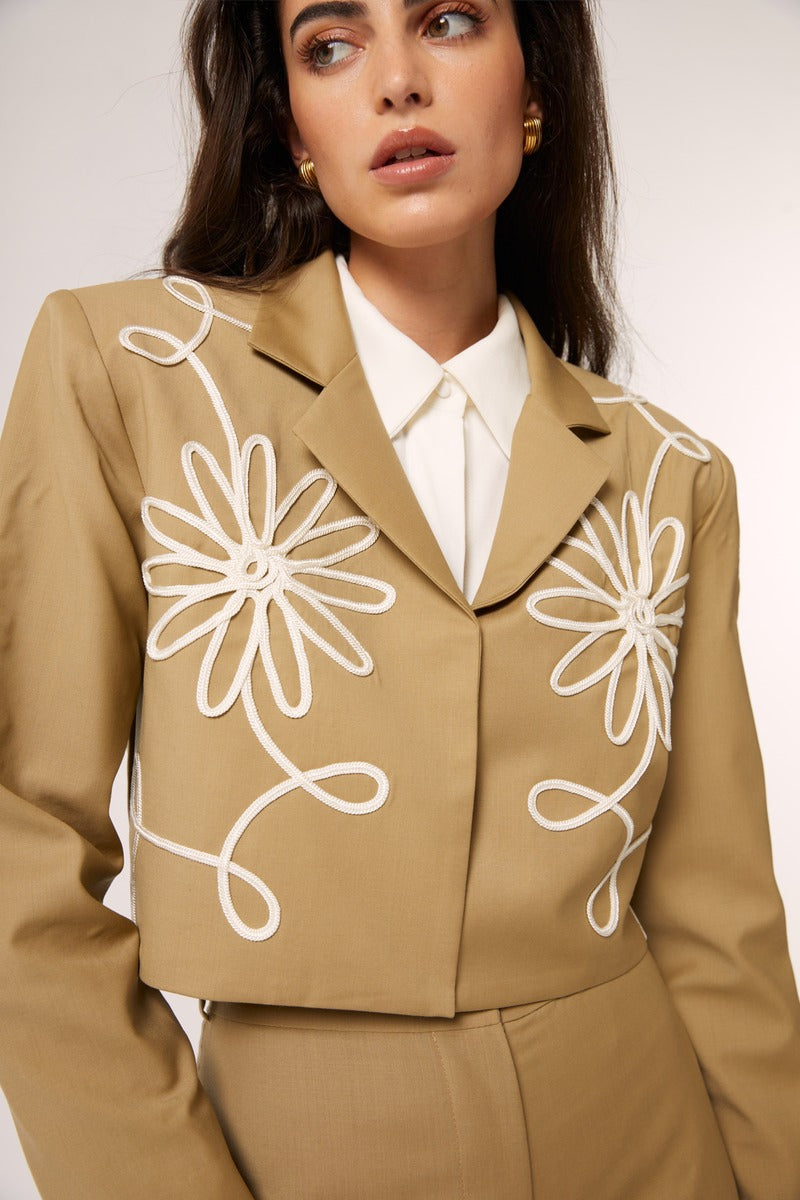 Beige Señorita Lara blazer jacket displayed on a hanger, showcasing tailored fit and classic blazer style.