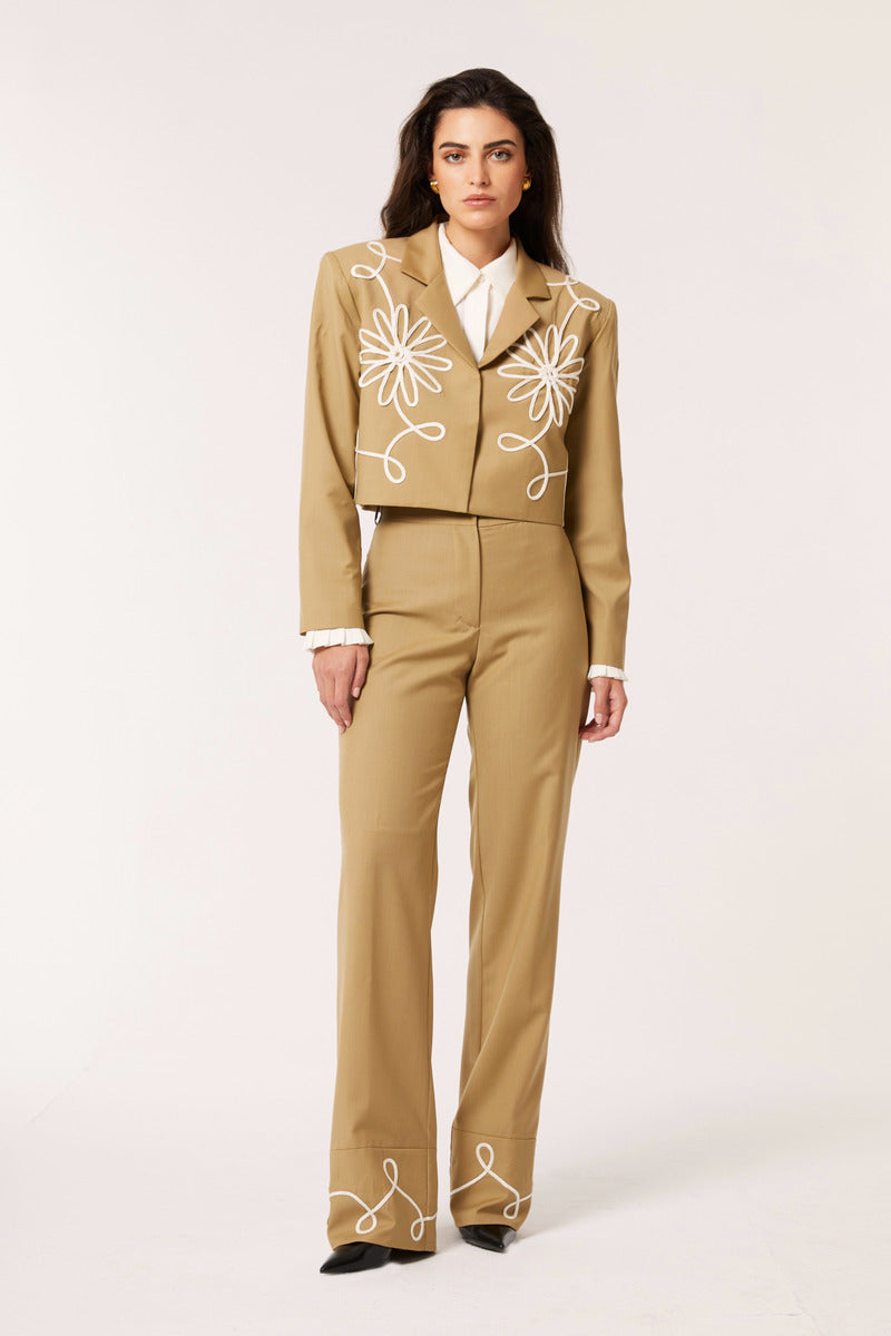 Señorita beige Lara blazer jacket hanging on a wooden hanger, showcasing tailored fit and classic blazer design.