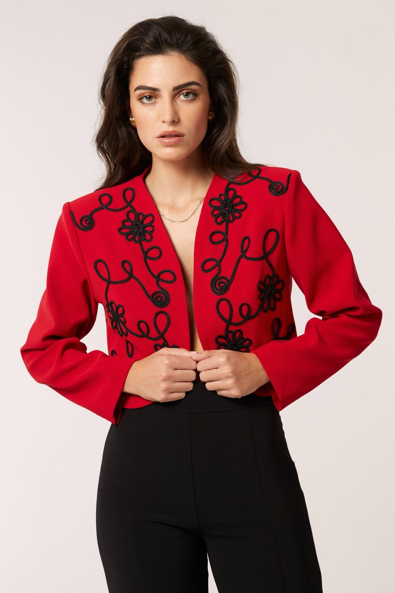 Red Señorita Rosalia jacket displayed on a hanger, showcasing its stylish design and vibrant color.