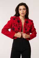 Red Señorita Rosalia jacket featuring stylish design, with a focus on the vibrant color and tailored fit, perfect for fashionable outerwear.