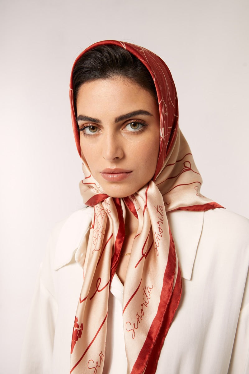 Red Señorita Luisa scarf featuring soft fabric and elegant drape, perfect for accessorizing outfits.