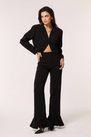Señorita Eugenia black pants with a relaxed fit, featuring a high waist and tapered legs, displayed on a model.