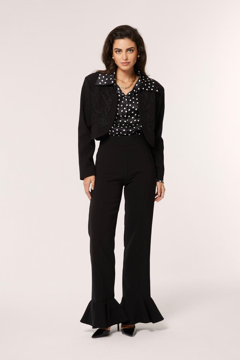Señorita Antonia polka dot blouse in black and white, lightweight shirt with long sleeves and a classic collar, on a hanger.