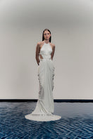 White VEYA gown by Francisco Arce, elegant dress with flowing fabric and intricate design, displayed on a mannequin.
