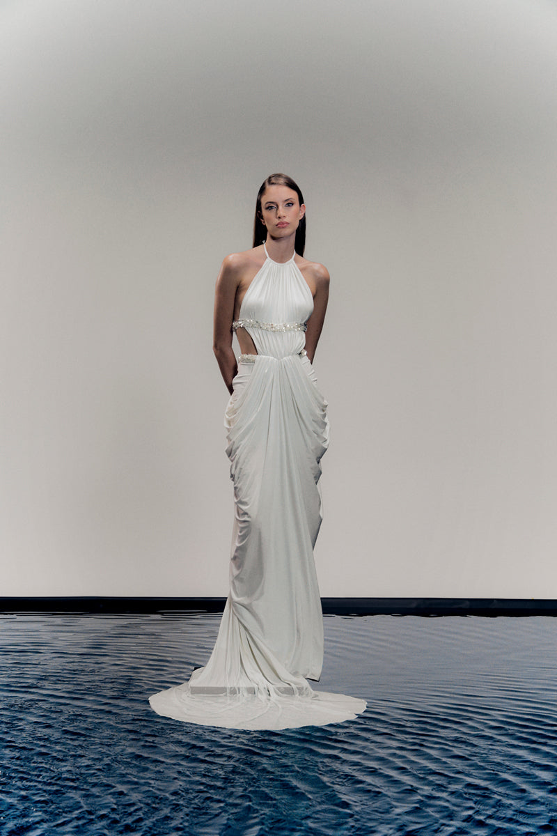 White VEYA gown by Francisco Arce, elegant dress with flowing fabric and intricate design, displayed on a mannequin.