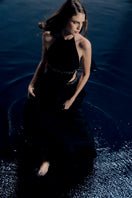 Black VEYA gown by Francisco Arce, featuring elegant fabric and a sophisticated design, displayed on a mannequin.