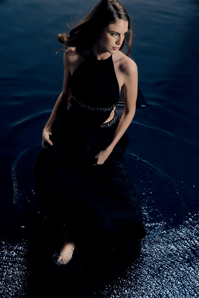 Black VEYA gown by Francisco Arce, featuring elegant fabric and a sophisticated design, displayed on a mannequin.