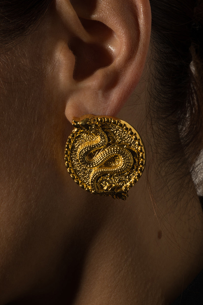 Natia x Lako dragon earrings featuring detailed metalwork and bold design, hanging from secure hooks.